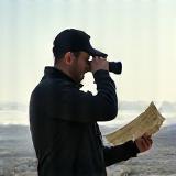 Person with camera looking at a map